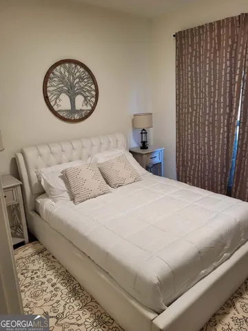 a bedroom with a bed and window