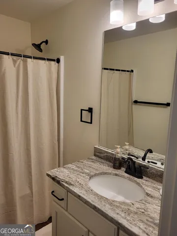 a white toilet sitting next to a shower
