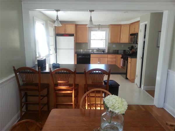 29 Myopia Road Boston, MA 02136 - Photo 4 of 17 a kitchen with a dining table chairs and refrigerator