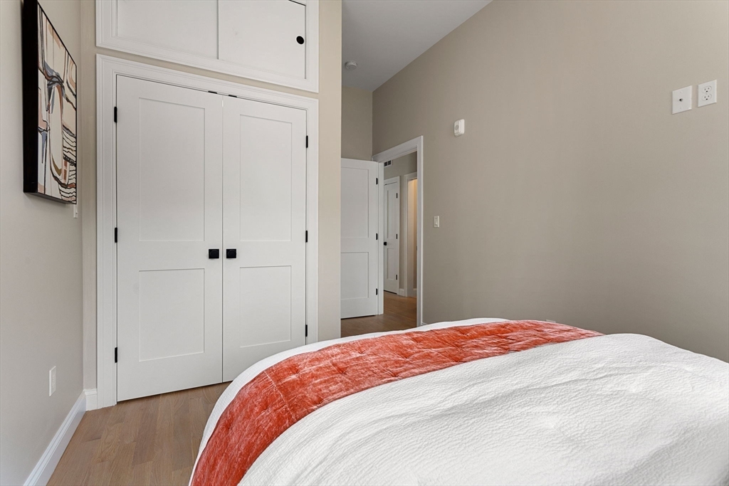 32 Wentworth Street, Unit 2 Boston, MA 02124 - Photo 17 of 23 a bedroom with a bed and a table