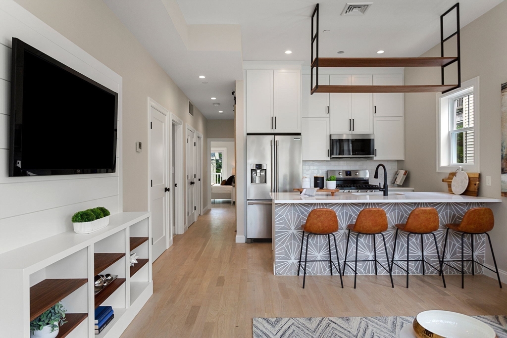 32 Wentworth Street, Unit 2 Boston, MA 02124 - Photo 2 of 23 a living room with stainless steel appliances furniture and a flat screen tv