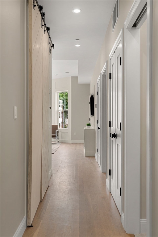 32 Wentworth Street, Unit 2 Boston, MA 02124 - Photo 10 of 23 a view of a hallway with wooden floor and a cabinet