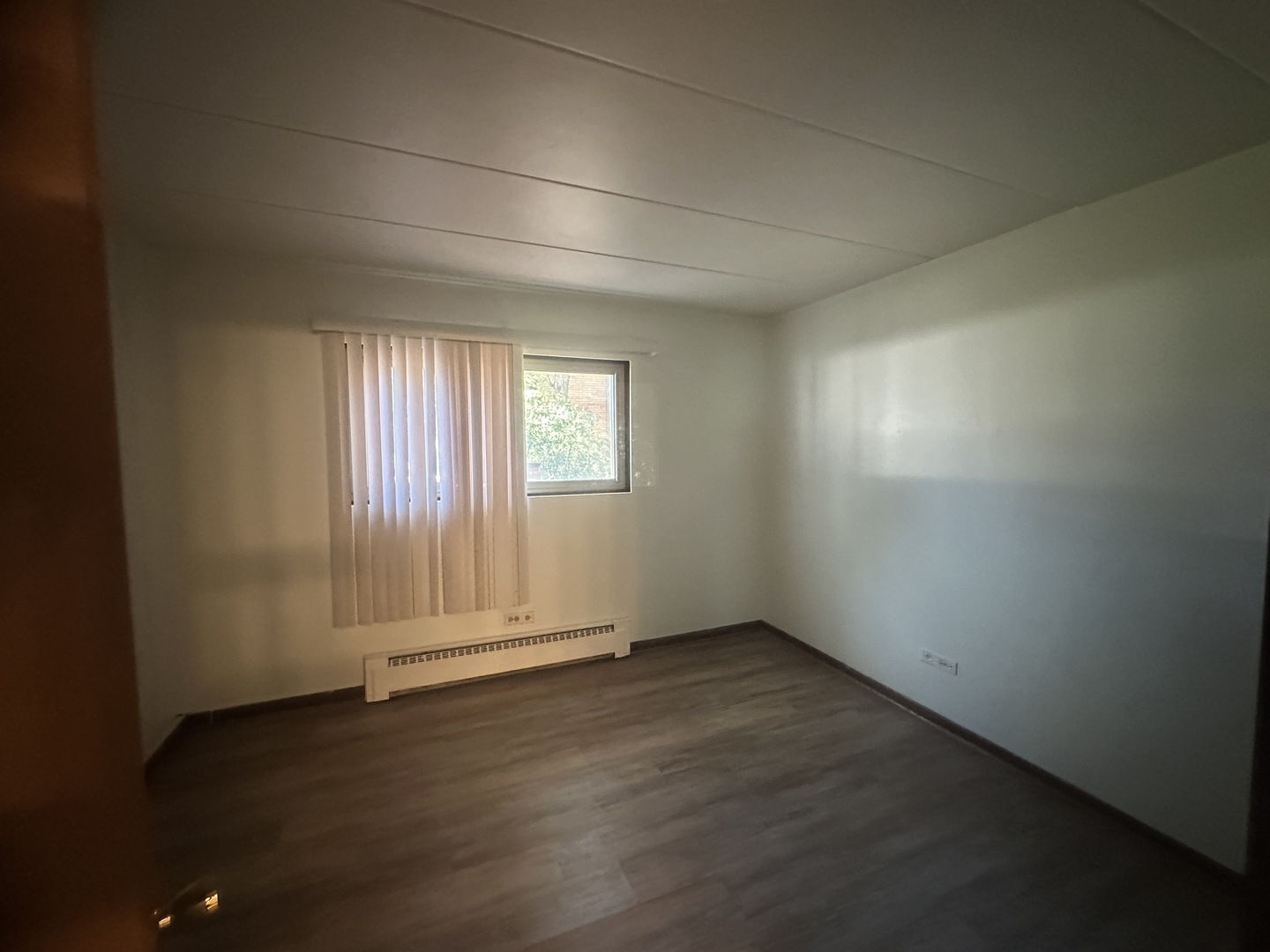 18550 Torrence Avenue, Unit 4 Lansing, IL 60438 - Photo 5 of 14 an empty room with wooden floor and windows