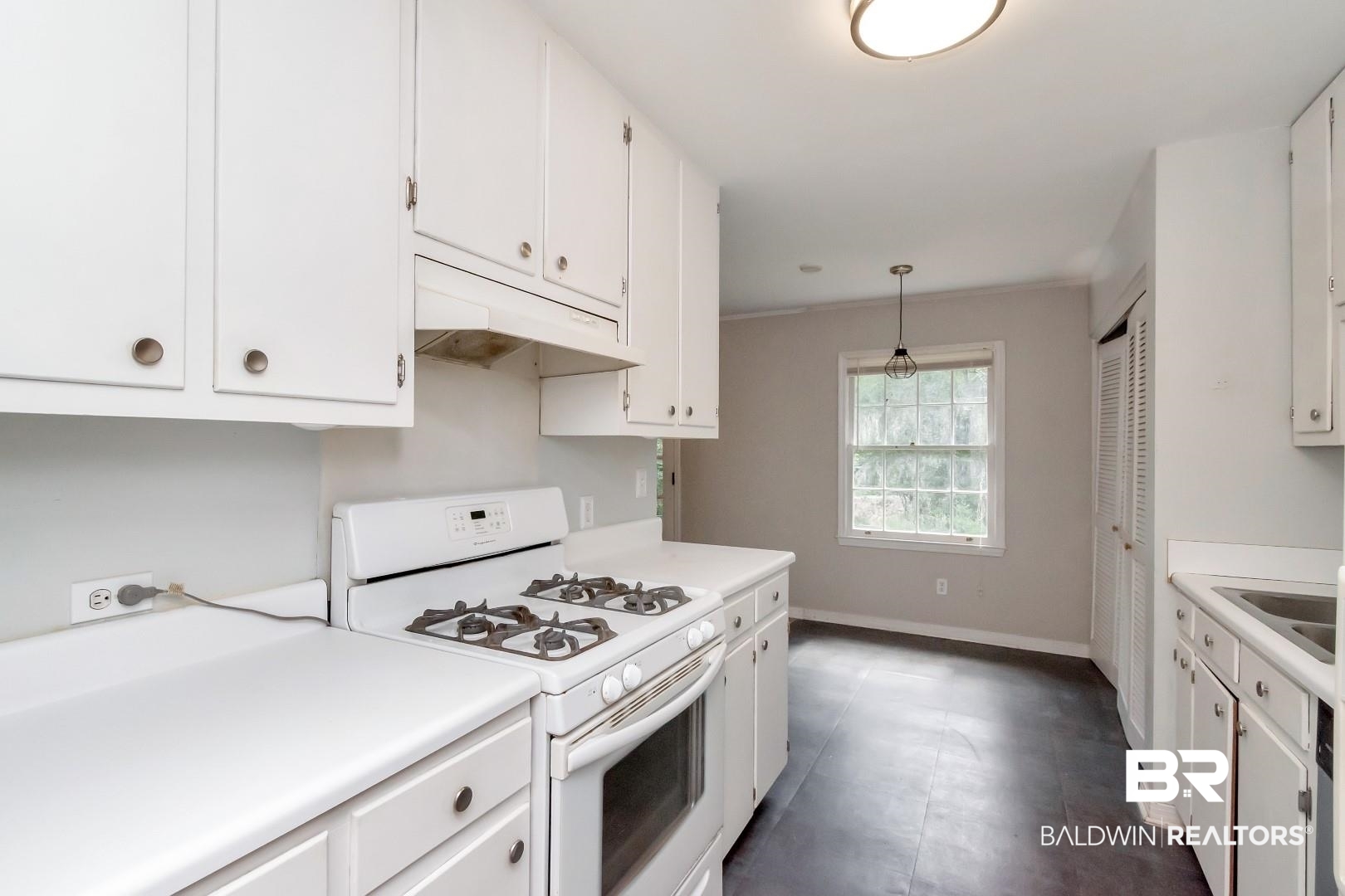 320 Vanderbilt Drive Mobile, AL 36608 - Photo 18 of 39 Kitchen with pendant lighting, white cabinetry, and white gas range oven