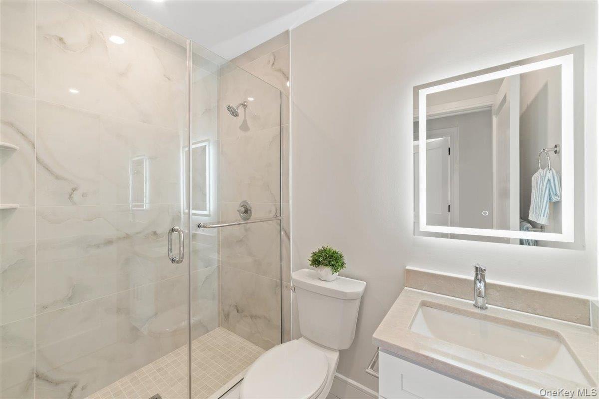 395 5th Avenue New Rochelle, NY 10801 - Photo 16 of 26 a bathroom with a sink toilet and shower