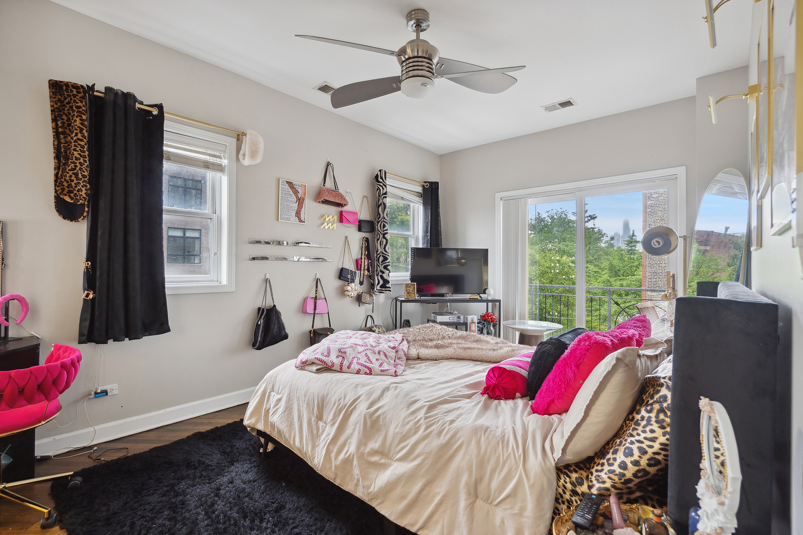 531 North Racine Avenue, Unit 3 Chicago, IL 60642 - Photo 12 of 22 a bedroom with a bed flat screen tv and a window