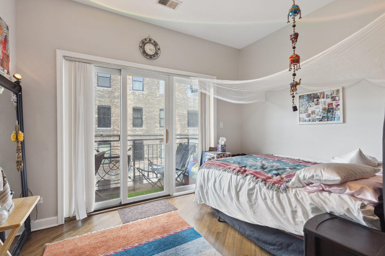 531 North Racine Avenue, Unit 3 Chicago, IL 60642 - Photo 15 of 22 a bedroom with a bed and a window