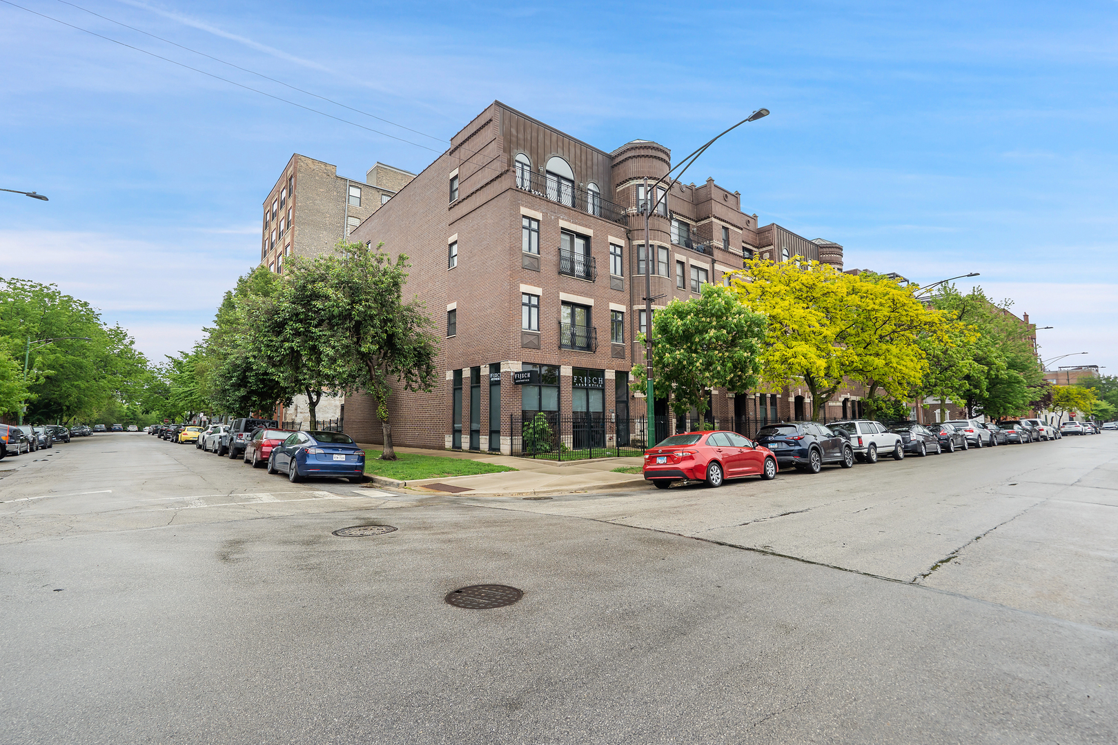 531 North Racine Avenue, Unit 3 Chicago, IL 60642 - Photo 22 of 22 a view of street with large trees and cars parked in front of it