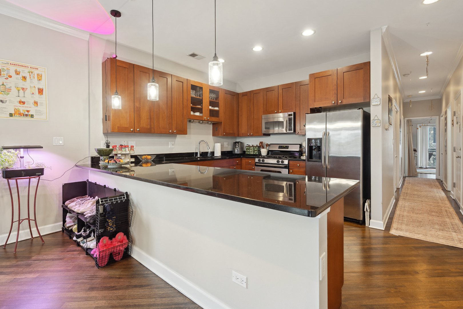 531 North Racine Avenue, Unit 3 Chicago, IL 60642 - Photo 8 of 22 a kitchen with stainless steel appliances kitchen island granite countertop a sink refrigerator and cabinets
