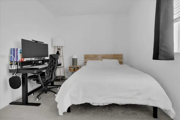 a bedroom with a bed and a window