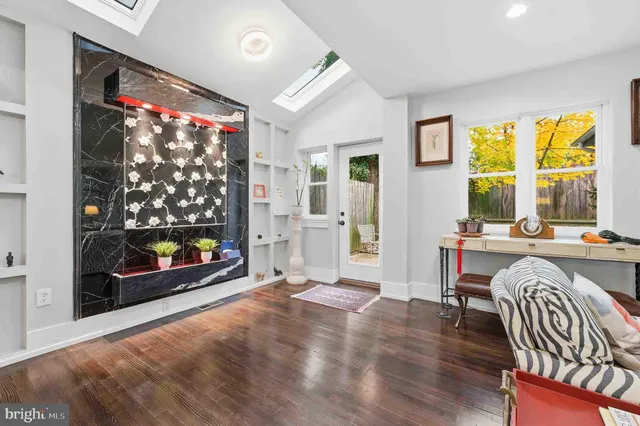 a living room with fireplace furniture and a flat screen tv