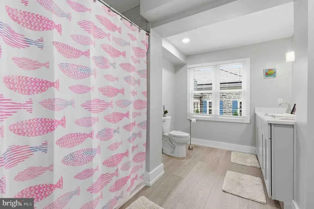 a bathroom with a sink toilet and shower