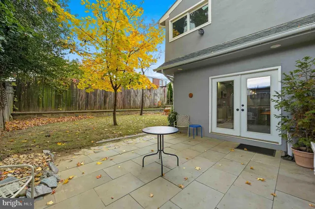 a view of a house with a tree in front of it