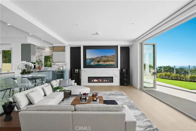 a living room with fireplace furniture and a large window