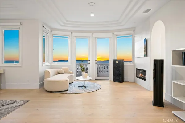 a living room with fireplace furniture and a floor to ceiling window