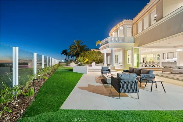 a view of a patio with couches table and chairs and potted plants