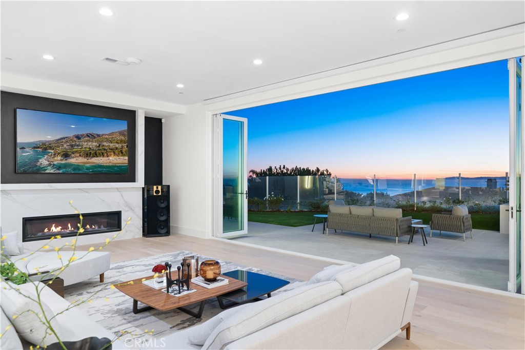9 Seashell Newport Coast, CA 92657 - Photo 4 of 45 a living room with furniture and a fireplace