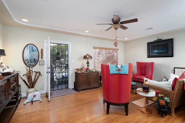 a living room with furniture and wooden floor