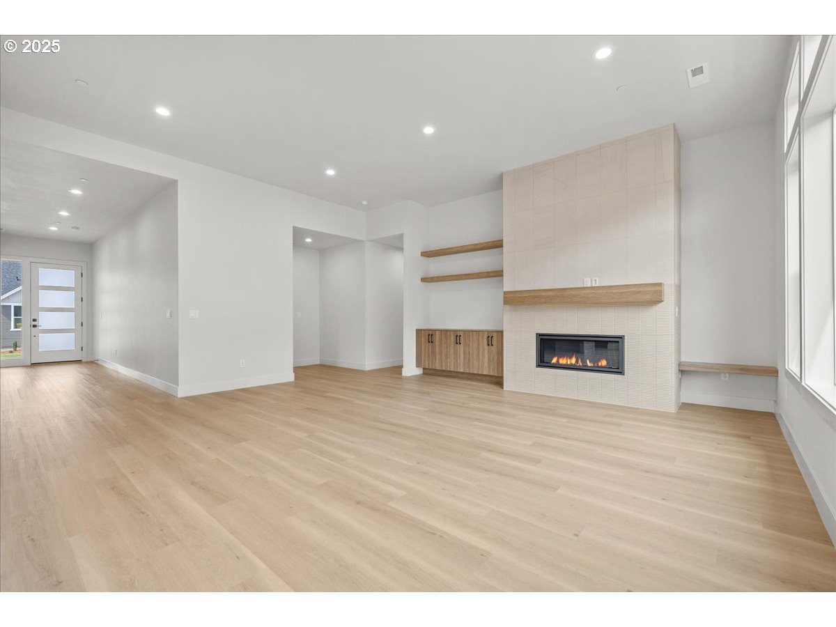 16705 Northeast 38th Avenue Vancouver, WA 98686 - Photo 11 of 45 a view of an empty room with wooden floor and a fireplace