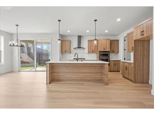 a view of kitchen with cabinets and refrigerator