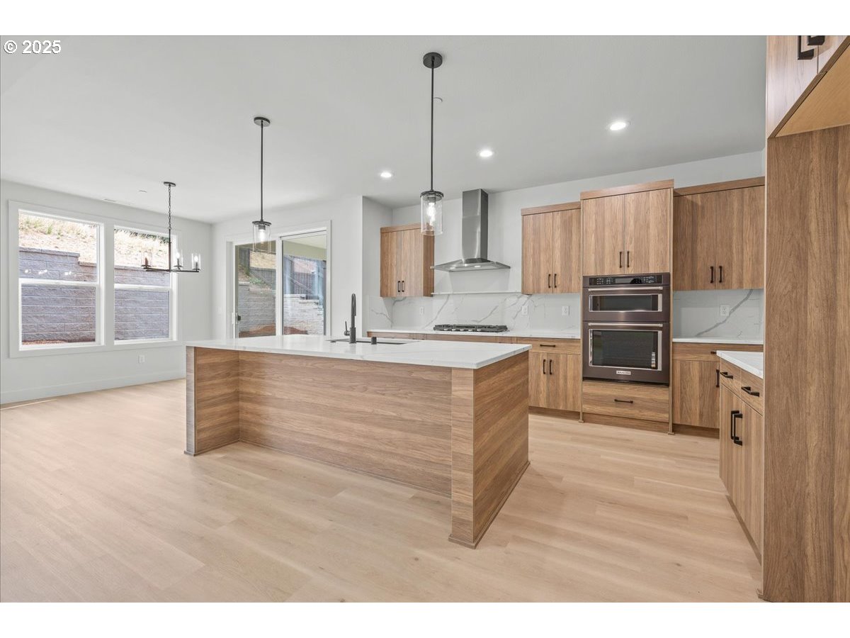 16705 Northeast 38th Avenue Vancouver, WA 98686 - Photo 17 of 45 a kitchen with kitchen island a counter top space appliances and a cabinets