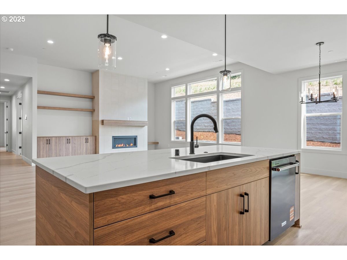 16705 Northeast 38th Avenue Vancouver, WA 98686 - Photo 19 of 45 a open kitchen with a sink a chandelier stainless steel appliances and cabinets