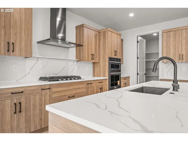 a kitchen with kitchen island granite countertop a view of living room