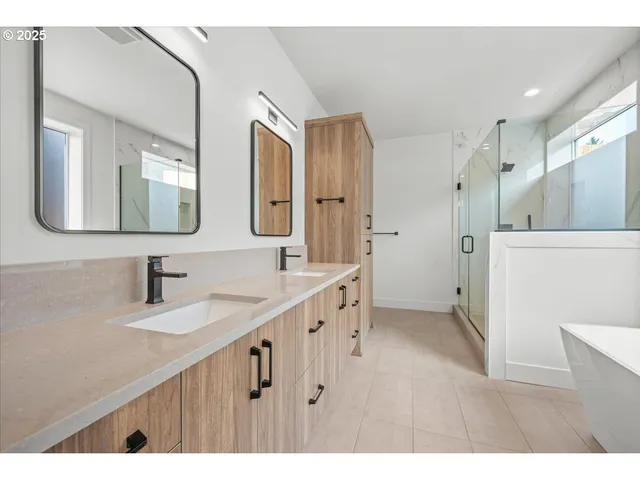 a bathroom with a double vanity sink mirror and