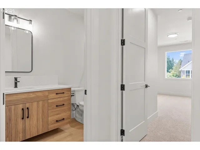 a bathroom with a sink a mirror and a window