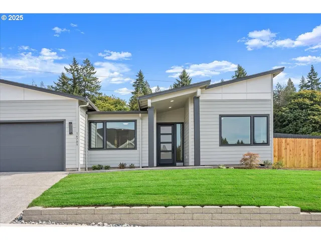 a front view of house with a garden