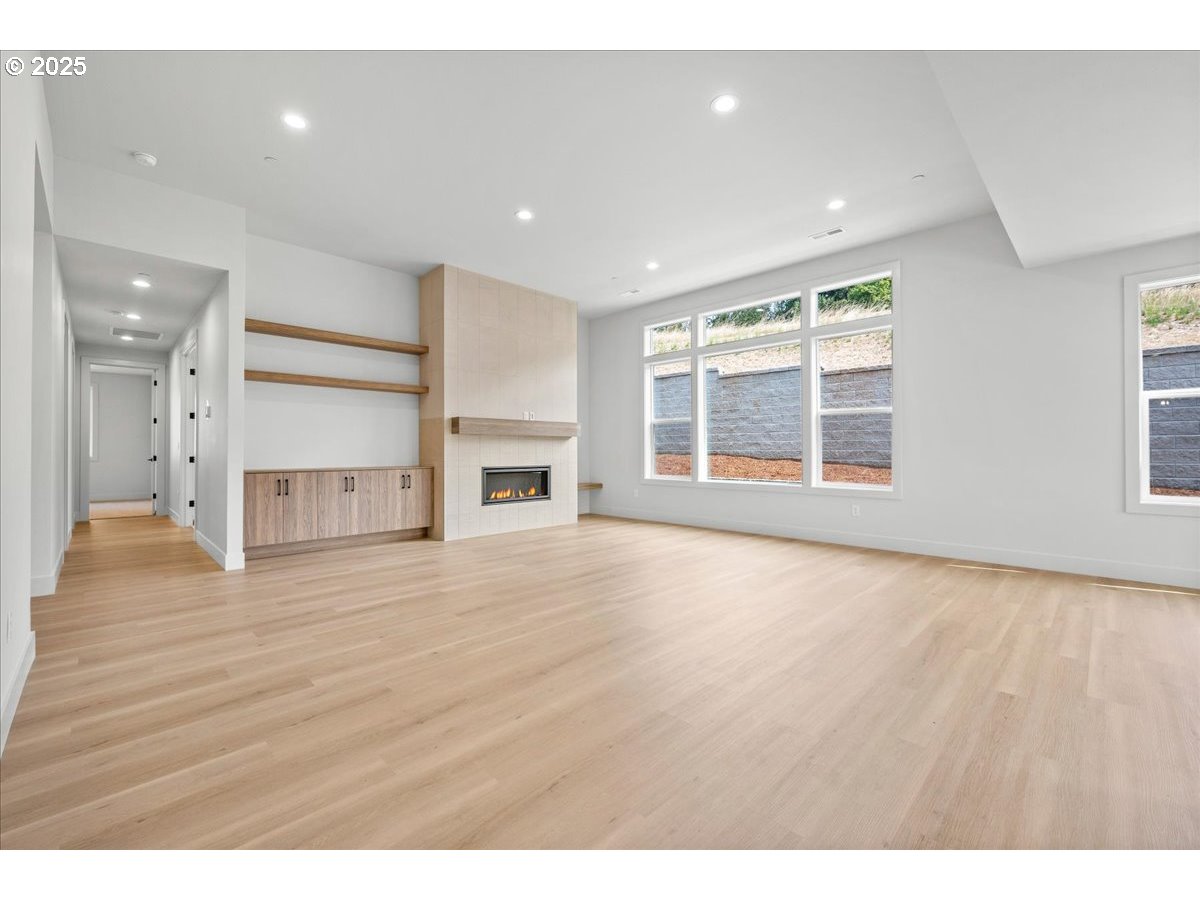 16705 Northeast 38th Avenue Vancouver, WA 98686 - Photo 7 of 45 a view of empty room with a fireplace and wooden floor