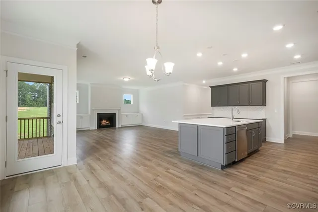 a kitchen with stainless steel appliances granite countertop a stove and a wooden floors