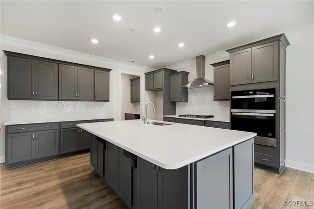 a kitchen with a sink a stove a refrigerator and cabinets