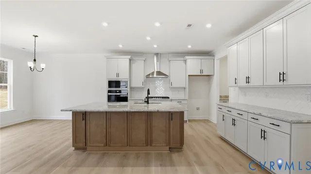 a kitchen with white cabinets a sink and a stove