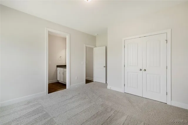 a white bath tub sitting next to a white toilet and vanity