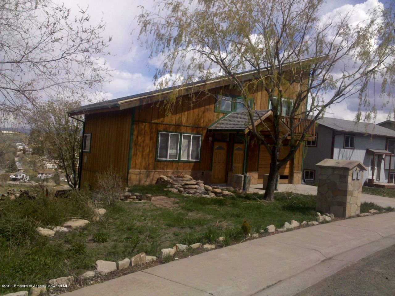 610 Hutton Avenue Rifle, CO 81650 - Photo 1 of 1 a front view of a house with a yard