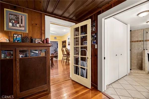 a view of a hallway with wooden floor and windows
