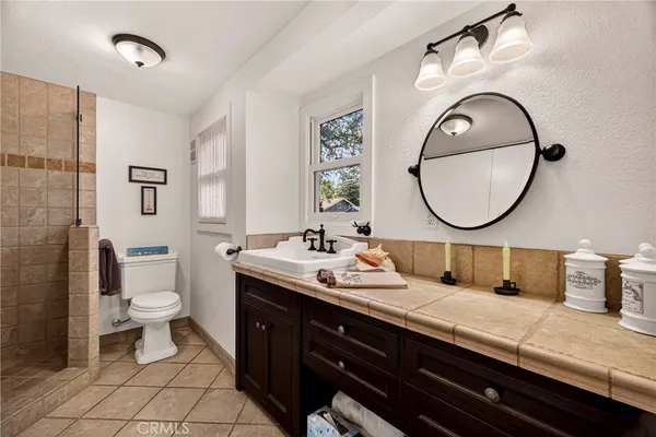 a bathroom with a double vanity sink and a toilet