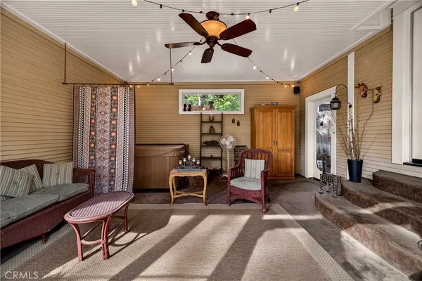 a bedroom with furniture and a large window