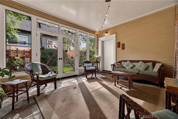 a living room with furniture and floor to ceiling windows