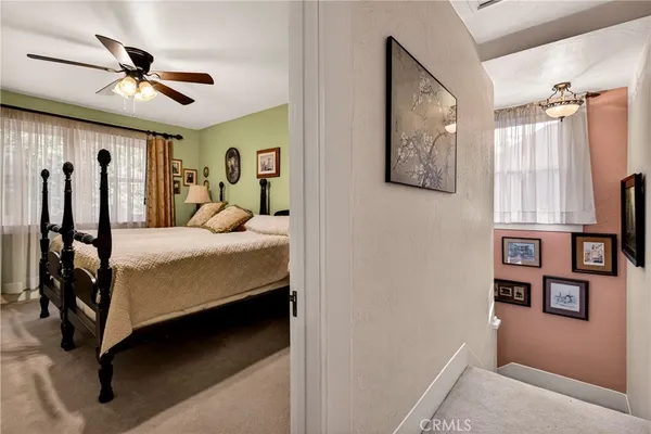 a bed room with a bed and a ceiling fan