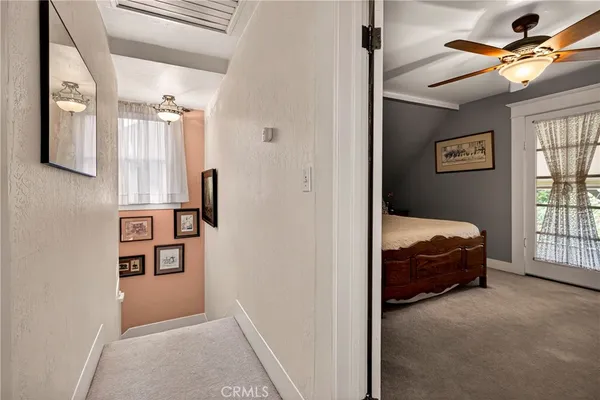 a bed room with a bed and a ceiling fan