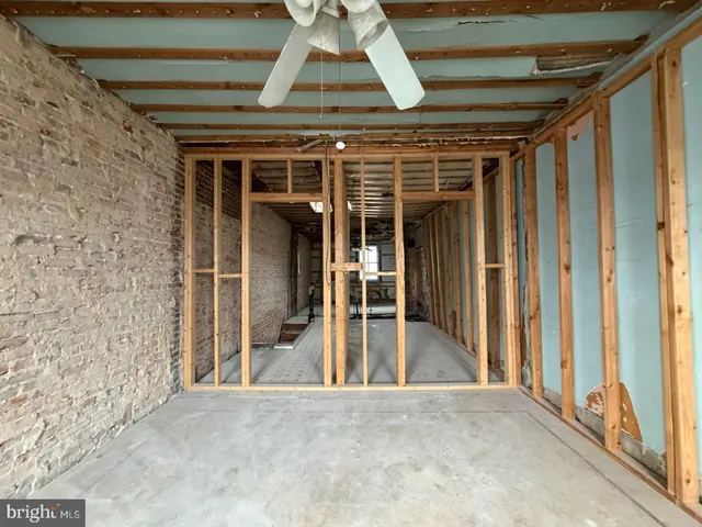 a view of a room with wooden floor and a fireplace