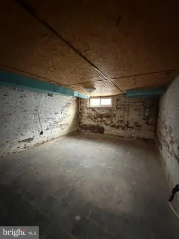 a view of an empty room with a fireplace and a window