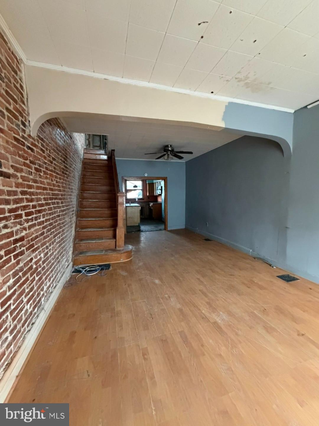 12 South Kresson Street Baltimore, MD 21224 - Photo 3 of 29 a view of an empty room with stairs and a window
