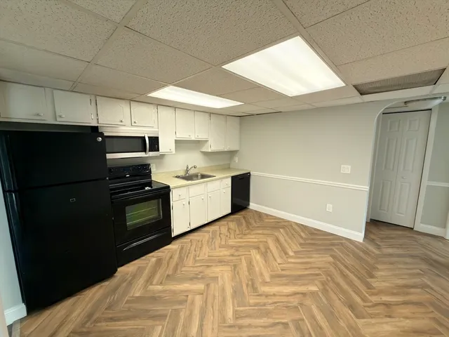 a room with a bed and cabinets
