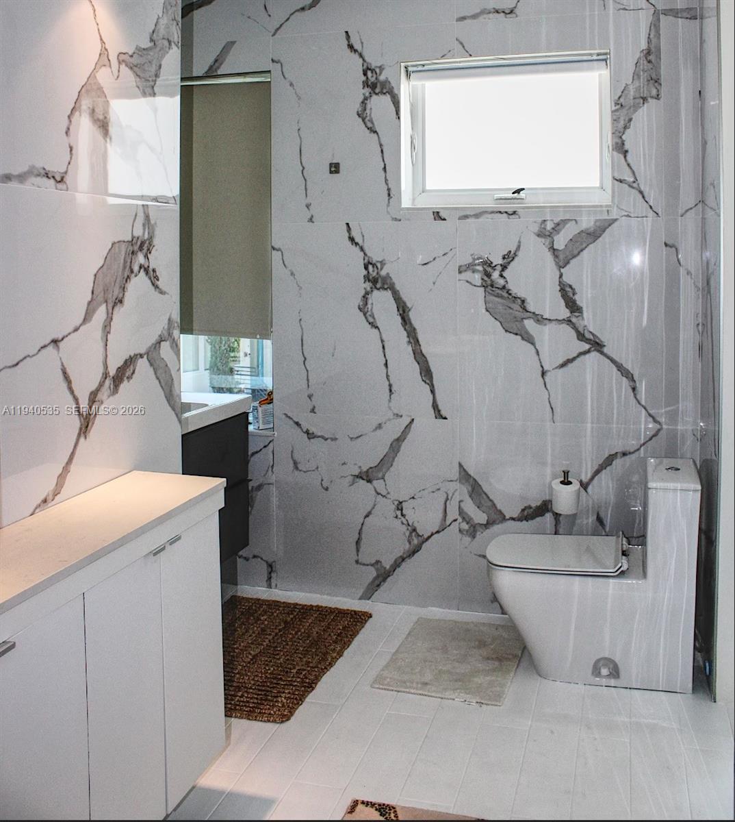 4710 Pine Tree Drive, Unit 49 Miami Beach, FL 33140 - Photo 18 of 26 a bathroom with a bathtub and a sink