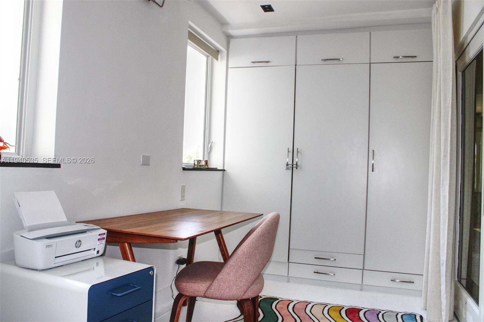 4710 Pine Tree Drive, Unit 49 Miami Beach, FL 33140 - Photo 19 of 26 a room that has a table and chair in it