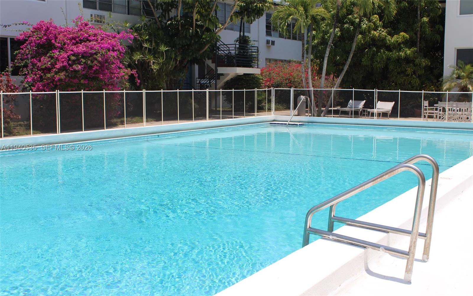 4710 Pine Tree Drive, Unit 49 Miami Beach, FL 33140 - Photo 26 of 26 a view of a chairs and table in the backyard