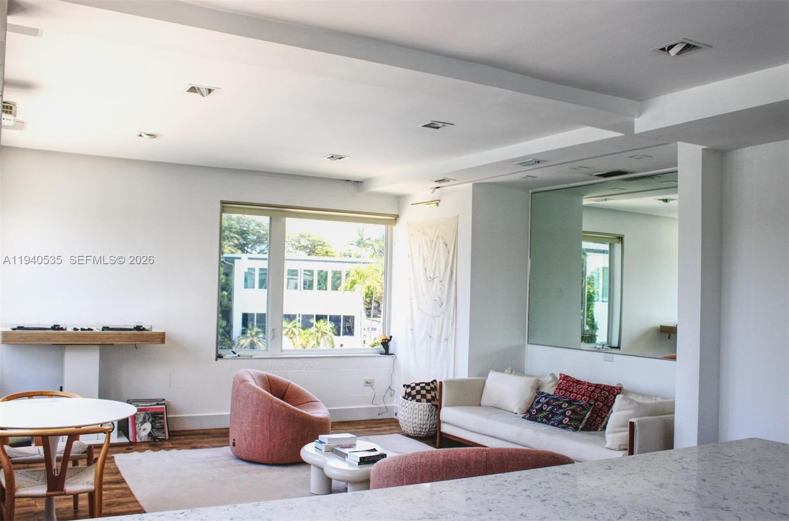 4710 Pine Tree Drive, Unit 49 Miami Beach, FL 33140 - Photo 3 of 26 a living room with furniture and a large window